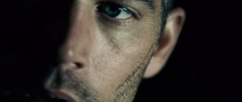 Movie still from “Running Scared” (2006), directed by Wayne Kramer – A man's face with scars on it; Extreme Close Up shot, Overhead angle