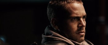 Movie still from “Running Scared” (2006), directed by Wayne Kramer – A man's face in a hooded jacket; Close Up shot, Over the shoulder angle