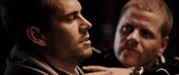 Movie still from “Running Scared” (2006), directed by Wayne Kramer – A person with his eyes closed; Close Up shot, Over the shoulder angle