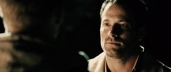 Movie still from “Running Scared” (2006), directed by Wayne Kramer – A person wearing a white shirt; Close Up shot, Over the shoulder angle