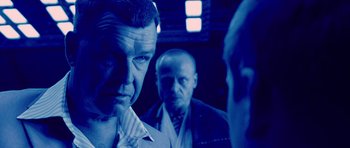 Movie still from “Running Scared” (2006), directed by Wayne Kramer – A group of men standing next to each other in a room; Close Up shot, Over the shoulder angle