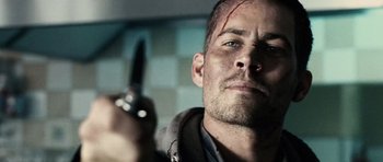 Movie still from “Running Scared” (2006), directed by Wayne Kramer – A person holding a cell phone; Close Up shot, Over the shoulder angle