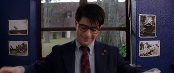 Movie still from “Rushmore” (1998), directed by Wes Anderson – A man in a suit and tie smiling; Close Up shot, Low angle