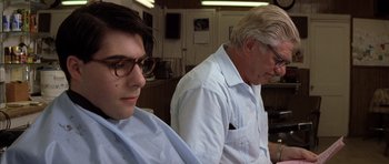 Movie still from “Rushmore” (1998), directed by Wes Anderson – A man sitting next to another man in front of a mirror; Close Up shot, Low angle