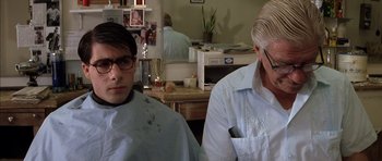 Movie still from “Rushmore” (1998), directed by Wes Anderson – Two men sitting in a barber shop waiting for a haircut; Close Up shot, Over the shoulder angle