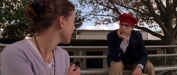 Movie still from “Rushmore” (1998), directed by Wes Anderson – A man and a woman sitting next to each other on a bench; Medium shot, Over the shoulder angle