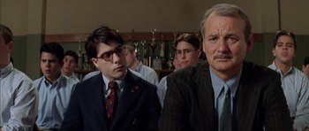 Movie still from “Rushmore” (1998), directed by Wes Anderson – Two men in suits and ties sitting next to each other in a bar; Close Up shot, Low angle