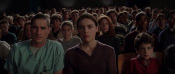 Movie still from “Rushmore” (1998), directed by Wes Anderson – A group of people sitting in front of each other; Medium shot, High angle