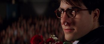 Movie still from “Rushmore” (1998), directed by Wes Anderson – A man with a bloody nose holding a bouquet of roses; Close Up shot, Low angle