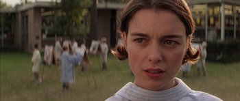 Movie still from “Rushmore” (1998), directed by Wes Anderson – A young woman is looking into the camera; Close Up shot, Over the shoulder angle