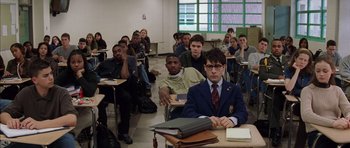 Movie still from “Rushmore” (1998), directed by Wes Anderson – A group of people sitting in a classroom; Medium shot, High angle