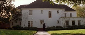 Movie still from “Rushmore” (1998), directed by Wes Anderson – An older man standing in front of a white house; Extreme Wide shot, Low angle