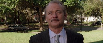 Movie still from “Rushmore” (1998), directed by Wes Anderson – An older man in a suit and a tie; Close Up shot, Low angle