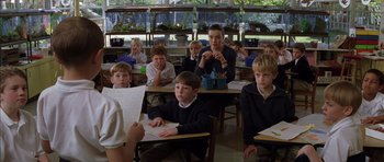 Movie still from “Rushmore” (1998), directed by Wes Anderson – A group of children sitting at desks in a classroom; Medium shot, Over the shoulder angle