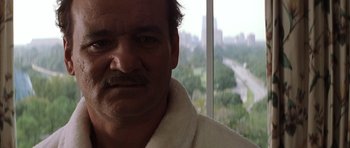 Movie still from “Rushmore” (1998), directed by Wes Anderson – A person wearing a bathrobe near a window; Close Up shot, Low angle