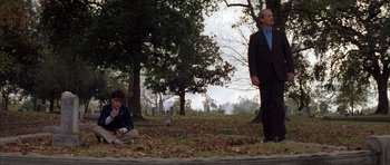 Movie still from “Rushmore” (1998), directed by Wes Anderson – A man in a suit stands in front of another man in a blue shirt; Wide shot, Over the shoulder angle