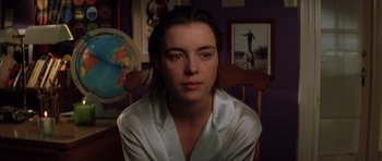 Movie still from “Rushmore” (1998), directed by Wes Anderson – A woman sitting in a chair in front of a globe; Close Up shot, Over the shoulder angle