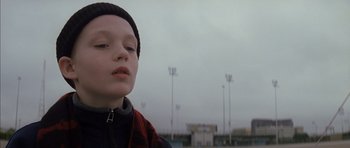 Movie still from “Rushmore” (1998), directed by Wes Anderson – A young boy in front of a field of lights; Close Up shot, Low angle