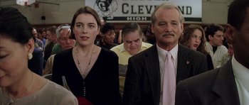 Movie still from “Rushmore” (1998), directed by Wes Anderson – A man and a woman standing next to each other; Close Up shot, Low angle