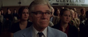 Movie still from “Rushmore” (1998), directed by Wes Anderson – An older man in a suit and glasses; Close Up shot, Over the shoulder angle