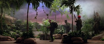 Movie still from “Rushmore” (1998), directed by Wes Anderson – A man in a jungle setting with a gun; Wide shot, High angle
