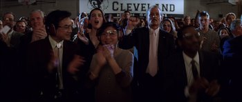 Movie still from “Rushmore” (1998), directed by Wes Anderson – A group of people standing in front of a cleveland sign; Medium shot, Low angle
