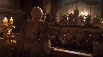 Movie still from “Russian Ark” (2002), directed by Aleksandr Sokurov – An old woman in a dress looking out of a window; Wide shot, High angle