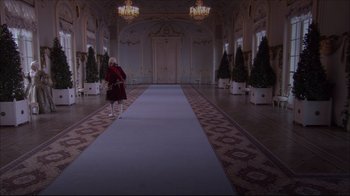Movie still from “Russian Ark” (2002), directed by Aleksandr Sokurov – A woman in a red dress standing in front of a blue carpet; Extreme Wide shot, High angle
