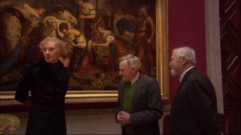 Movie still from “Russian Ark” (2002), directed by Aleksandr Sokurov – A group of people standing in front of a painting; Wide shot, Over the shoulder angle
