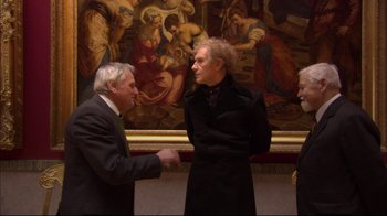 Movie still from “Russian Ark” (2002), directed by Aleksandr Sokurov – Two men in suits and a woman in a black dress; Wide shot, Over the shoulder angle