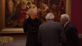 Movie still from “Russian Ark” (2002), directed by Aleksandr Sokurov – A man standing next to two other men in front of a painting; Medium shot, High angle