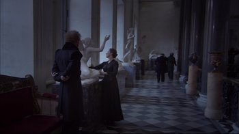 Movie still from “Russian Ark” (2002), directed by Aleksandr Sokurov – Two people in a room with a statue in the background; Wide shot, Over the shoulder angle