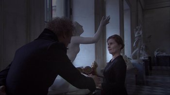 Movie still from “Russian Ark” (2002), directed by Aleksandr Sokurov – A man and a woman working together on a statue; Medium shot, Over the shoulder angle
