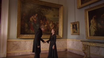 Movie still from “Russian Ark” (2002), directed by Aleksandr Sokurov – A man and a woman shaking hands in front of a painting; Wide shot, Low angle