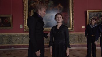 Movie still from “Russian Ark” (2002), directed by Aleksandr Sokurov – Two people standing next to each other in front of a painting; Medium shot, Low angle