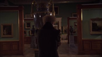 Movie still from “Russian Ark” (2002), directed by Aleksandr Sokurov – A person standing in front of a vase in a room; Medium shot, Low angle