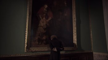 Movie still from “Russian Ark” (2002), directed by Aleksandr Sokurov – A man standing in front of a painting; Medium shot, Over the shoulder angle