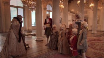 Movie still from “Russian Ark” (2002), directed by Aleksandr Sokurov – A group of people dressed in period costumes in front of a statue; Wide shot, High angle