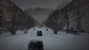 Movie still from “Russian Ark” (2002), directed by Aleksandr Sokurov – A person walking in the snow near a building; Extreme Wide shot, High angle