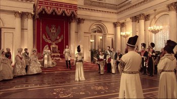 Movie still from “Russian Ark” (2002), directed by Aleksandr Sokurov – A group of people standing in a large room; Extreme Wide shot, High angle