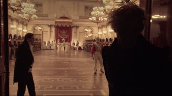 Movie still from “Russian Ark” (2002), directed by Aleksandr Sokurov – A man taking a picture in a large room; Wide shot, Over the shoulder angle