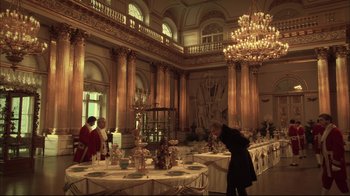 Movie still from “Russian Ark” (2002), directed by Aleksandr Sokurov – A man standing in front of a dining room table; Extreme Wide shot, Low angle