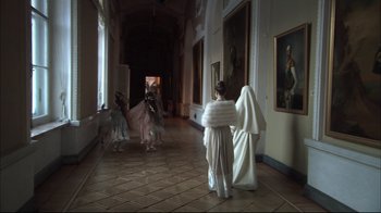 Movie still from “Russian Ark” (2002), directed by Aleksandr Sokurov – A group of people dressed up in costumes in a room; Wide shot, Low angle