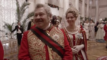 Movie still from “Russian Ark” (2002), directed by Aleksandr Sokurov – A man and a woman dressed up in costume; Close Up shot, Over the shoulder angle
