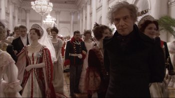 Movie still from “Russian Ark” (2002), directed by Aleksandr Sokurov – A group of people dressed up in costumes in a room; Medium shot, Over the shoulder angle