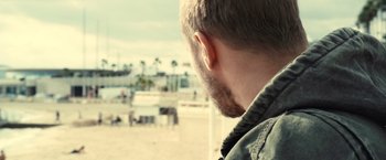 Movie still from “Rust and Bone” (2012), directed by Jacques Audiard – A person's face with a beach in the background; Close Up shot, Over the shoulder angle