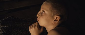 Movie still from “Rust and Bone” (2012), directed by Jacques Audiard – A young boy is looking up at the sky; Close Up shot, High angle