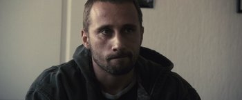 Movie still from “Rust and Bone” (2012), directed by Jacques Audiard – A person with a beard; Close Up shot, Over the shoulder angle