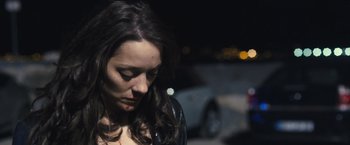 Movie still from “Rust and Bone” (2012), directed by Jacques Audiard – A person with long hair; Close Up shot, High angle