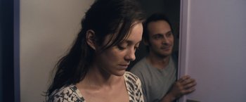 Movie still from “Rust and Bone” (2012), directed by Jacques Audiard – A woman and a man standing next to each other; Close Up shot, Over the shoulder angle